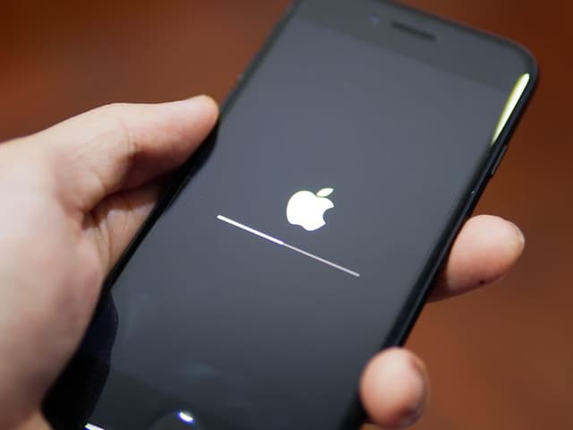 Apple iPhone showing its screen with Apple logo
