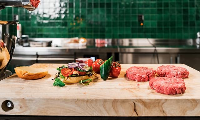 Burger bread with vegetables and 3 raw burgers