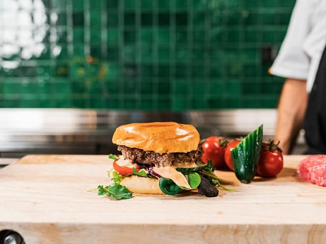 Burger with chef in the background