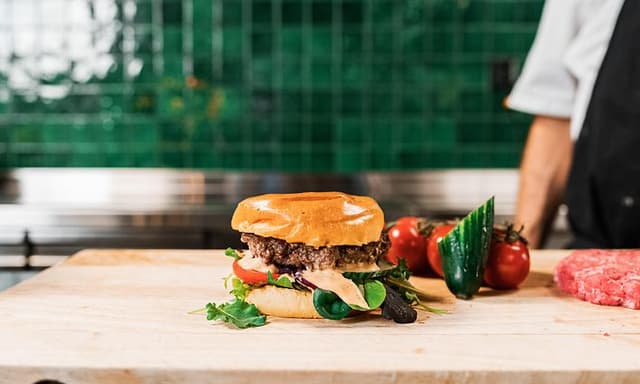 Burger with chef in the background