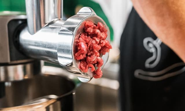 Meat coming out of grinder