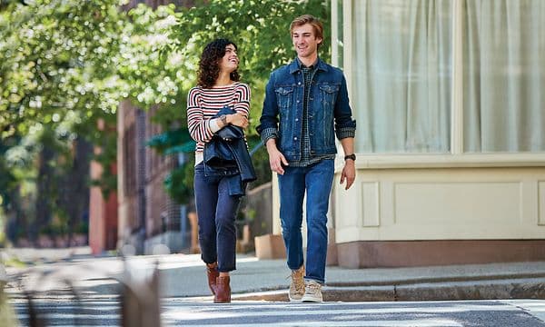 Man och kvinna går med smartwatches på handleden