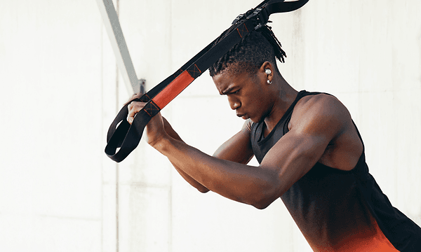 Man with in-ears using straps