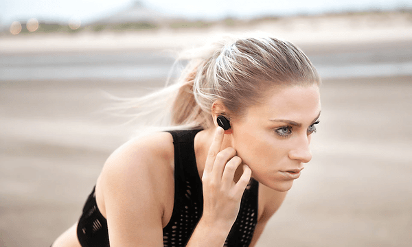 Woman with Bose headphones on beach