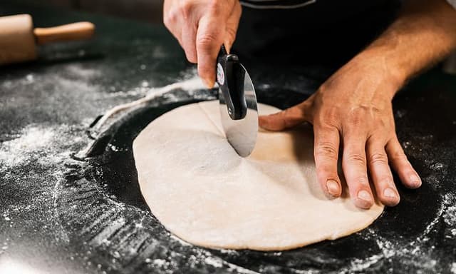 Chef cutting pasta dough