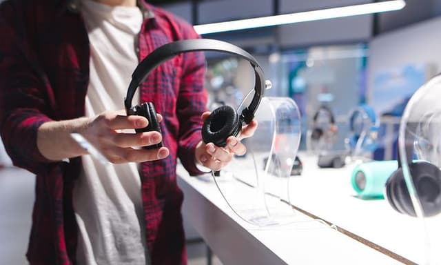 Man choosing headphones in a store