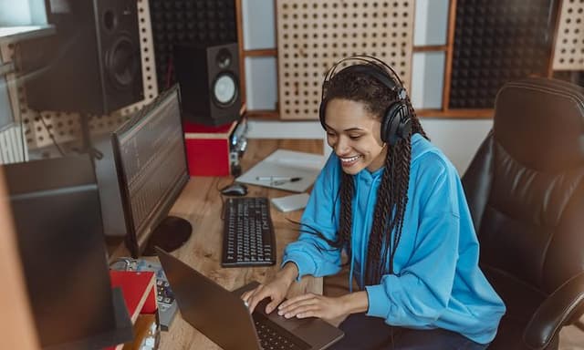 Woman mixes music with headphones on