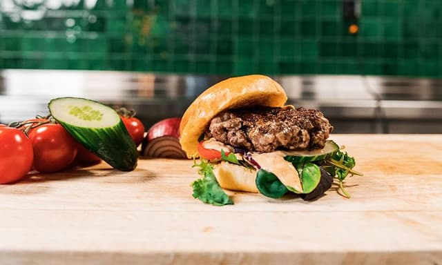 Burger next to vegetables