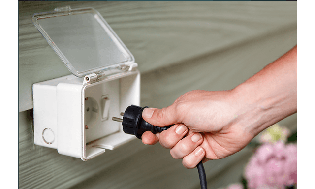 Hand inserting plug in socket
