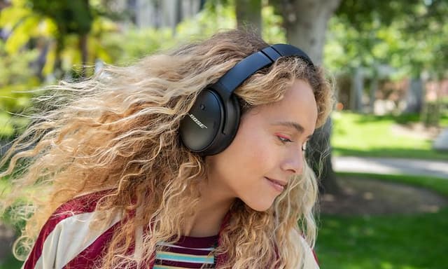 Woman in profile wearing Bose QC45 headphones