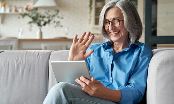 Woman smiling at tablet