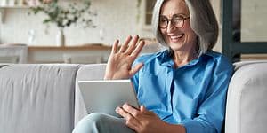 Woman smiling at tablet