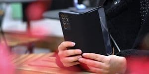 Telecom - Change Android old to new . A person holding a phone against a table