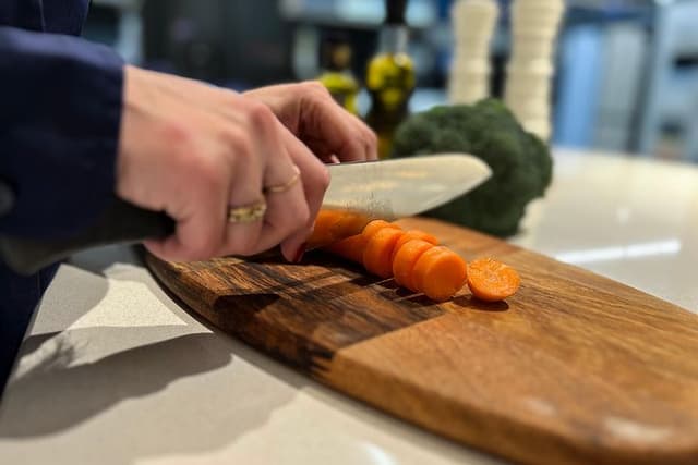 Woman cutting vegetables on a cutting board