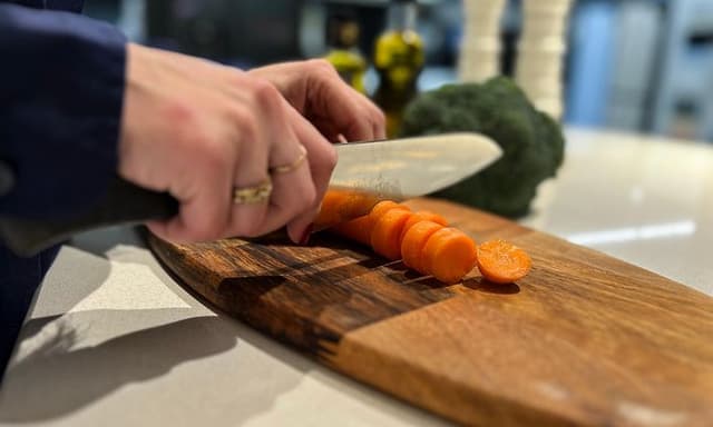 Woman cutting vegetables on a cutting board