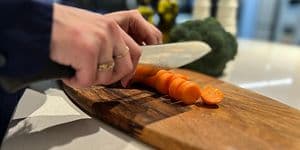 Woman cutting vegetables on a cutting board