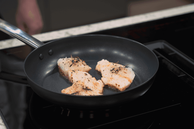 Fish being fried on a frying pan