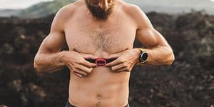 A man attaching a heart rate monitor to his chest