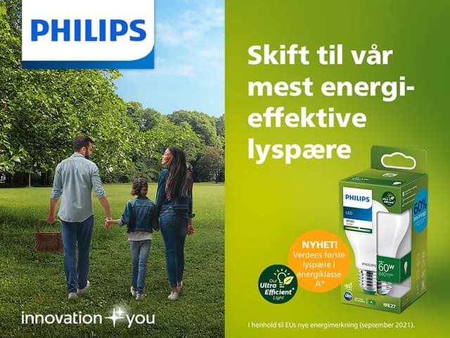 Philips-logo, Familie i grønt landskap og teksten Skift til vår mest energieffektive lyspøre
