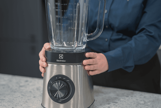 SDA - Blender - A woman holding a blender on a table