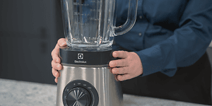 SDA - Blender - A woman holding a blender on a table