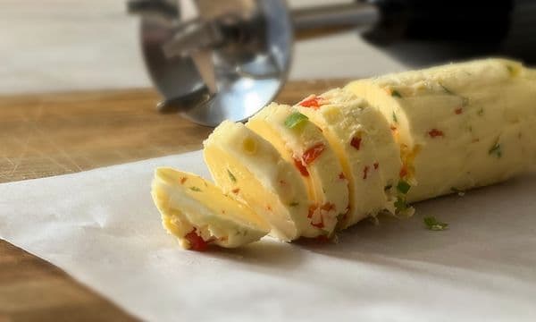 SDA - Blender - Seasoned butter on a table with a hand blender in the background