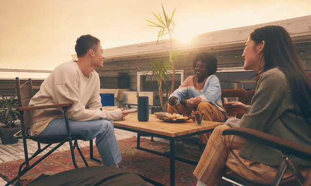 People outside with speaker on table