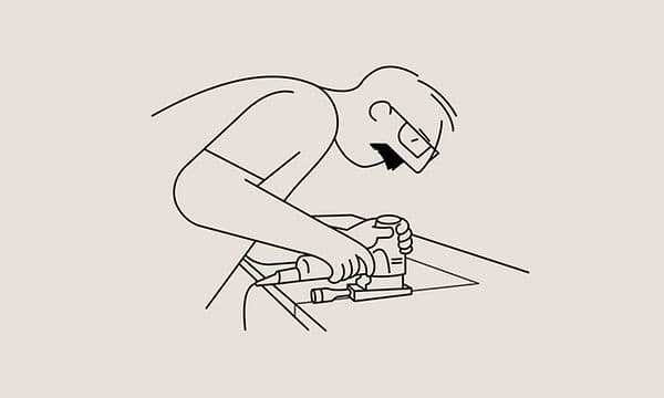 Illustration av en man som sågar i en bänkskiva med en elektrisk såg