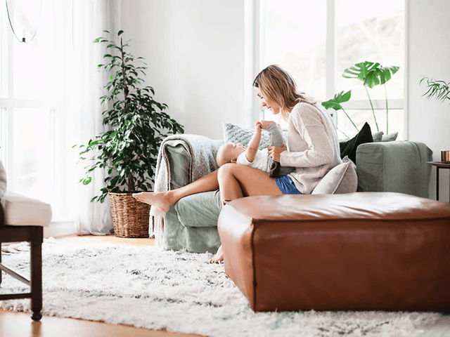 woman sitting in a couch with her child