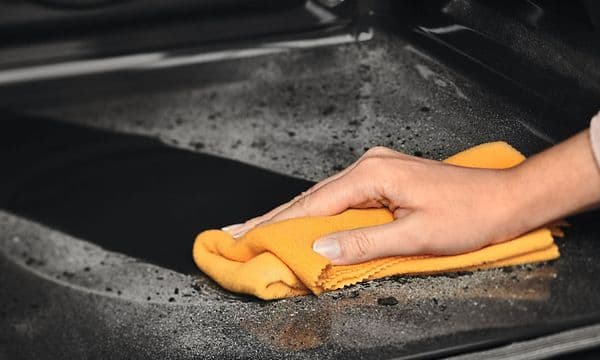 Pyrolytic Cleaning function and a hand cleaning the inside of an Electrolux Steam oven