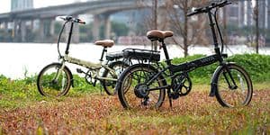 Picture of two electric bikes on a field in a city