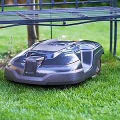 Robot lawn mover under a trampoline