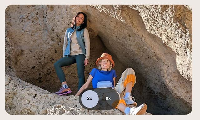 Two women at a cave photographed with high resolution zoom
