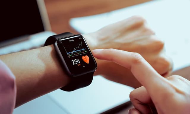 Close up of a hand touching smartwatch with health app on the screen