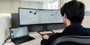 B2B - Computing - Bigger monitor - Office employee working with ultra-wide screen