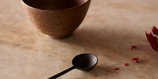 A spoon and bowl on a dekton worktop