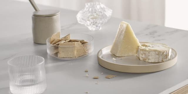 Plates with cheese and bisquits on a dekton worktop