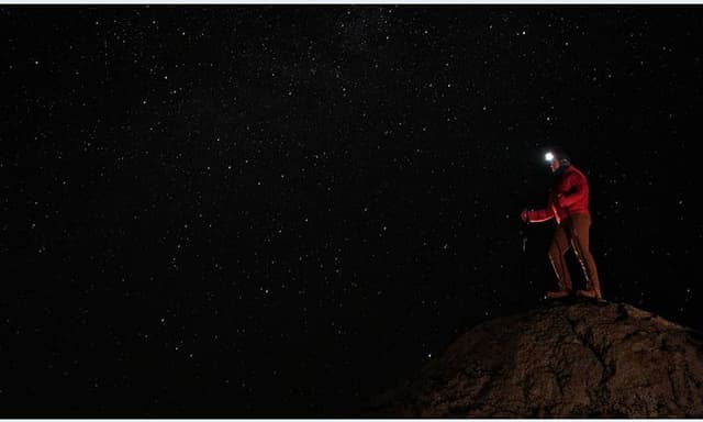 Man on a mountain in the dark