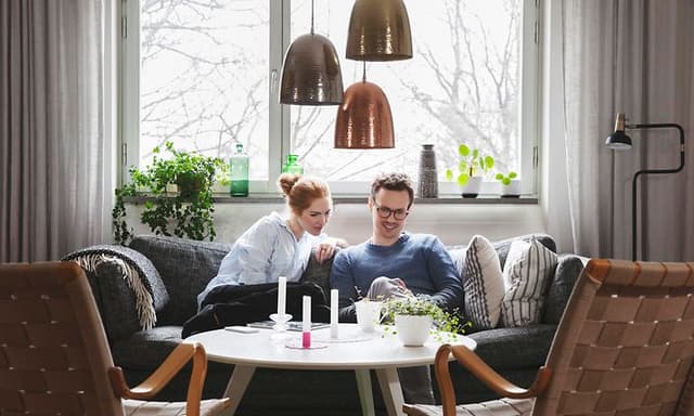 Woman and man sitting on a couch in a living room