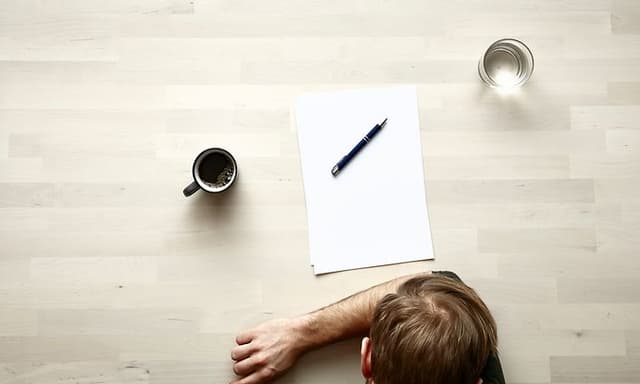 Me-time - man's head, paper and pen seen from above