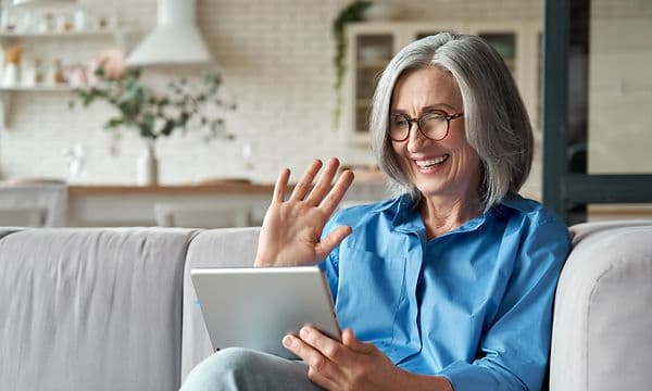 Woman smiling at tablet