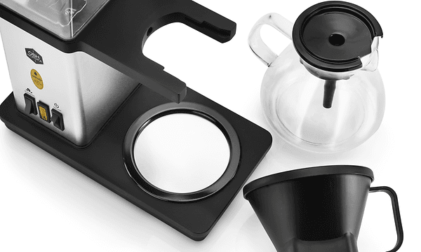 OBH Nordica Blooming coffee maker and it's pot at filter funnel on a white table