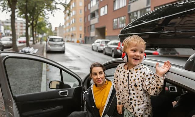 Kid with headset waving from car
