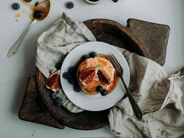 Pancake Day 2024 - Stack of pancakes with syrup, figs, and blueberries