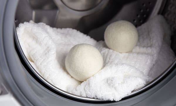 White towels and dryer balls inside a dryer