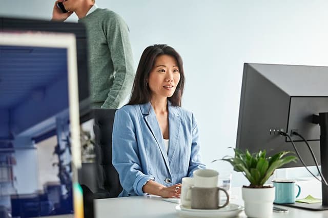 Business woman sitting in the office, working on her computer