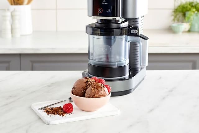 Ninja Creami Ice cream Machine on a Kitchen bench with a bowl with Chocolate Ice Cream