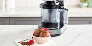Ninja Creami Ice cream Machine on a Kitchen bench with a bowl with Chocolate Ice Cream