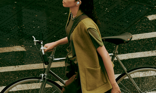 Woman with bike and Bose QuietComfort Earbuds