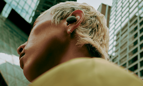 Man in city with Bose QuietComfort Earbuds
